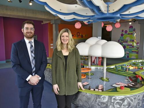 Professor Zachary Gold and Executive Director Kathryn Watson on the first floor of the Children's Museum in front of the water table