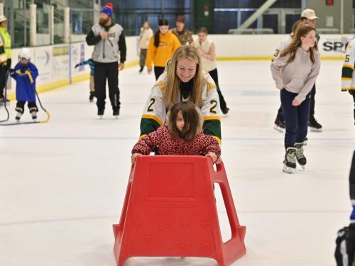 Mack Hall skates with a young Laker fan