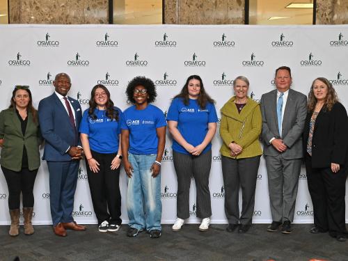 ACE students, Oswego administrators, local officials and Donna Linderman from SUNY
