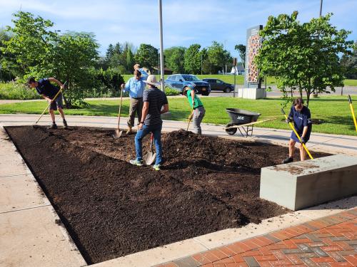 Student and staff volunteers planting the alvar garden outside Shineman Center.