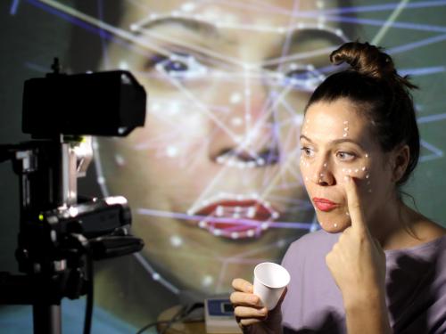 Mutlimedia performer Anna Oxygen works with eye tracking software in building a 3D creation