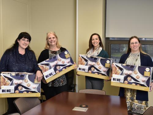 Four winners of the SEFA Bake Off receive baking sets as prizes