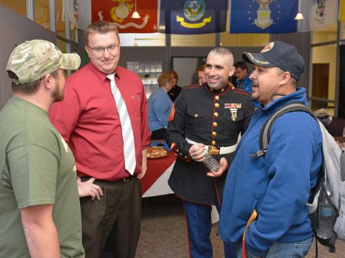 Ben Parker (second from left), coordinator of veteran and military services, speaks with student veterans at a Veterans Day open house. 