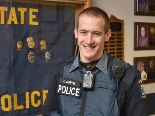 University Police Officer Eric Martin showing body-worn camera