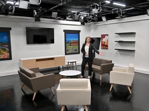 Jennifer Knapp, dean of SUNY Oswego's College of Communication, Media and the Arts, shows off a Hewitt Hall broadcast studio set to visitors just before the start of fall classes.