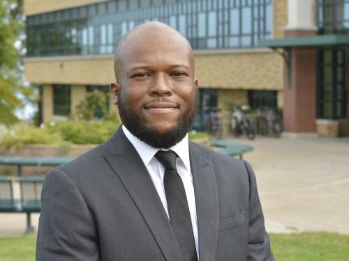 Dr. Isiah Brown stands outside Rich Hall, the college's School of Business
