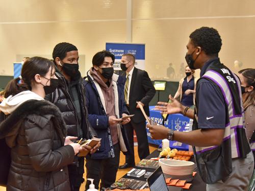 Students speak to a representative at the spring 2022 career and internship fair
