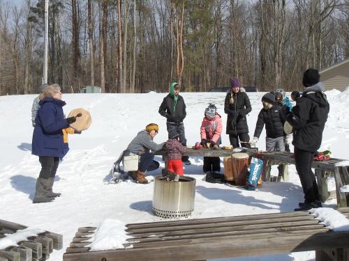 Rice Creek Field Station naturalist Linda Knowles leads a percussion circle by the campfire