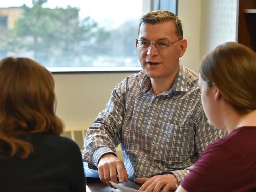 Faculty member Fehmi Damkaci speaks with students