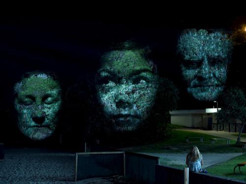 Project visual art of three faces by Craig Walsh at a previous installation in Australia