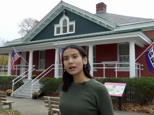 Senior broadcasting & mass communication major Clarissa Karki in front of the Safe Haven museum in Oswego.
