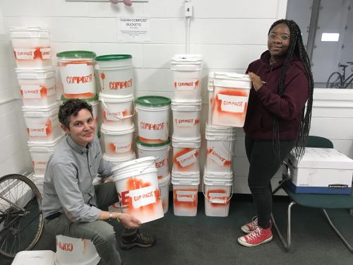 Kate Spector and Dee Canty show off Compozt buckets, which have collected more than a ton of dining hall waste to turn into compost