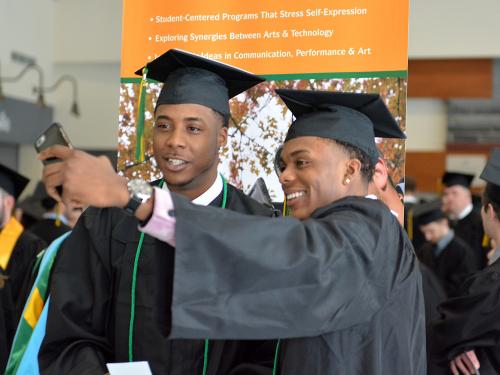 Two students take selfie before December Commencement