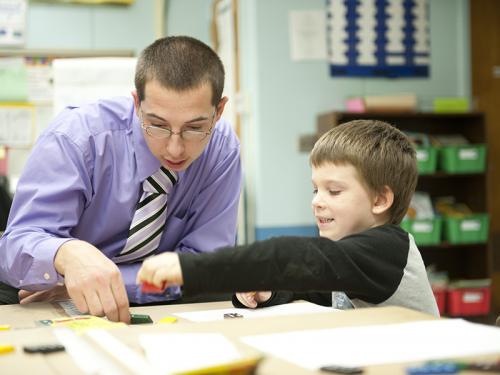 Oswego student teaching in a children's classroom with student