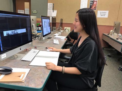 Jingyuan Duan works on her art via computer