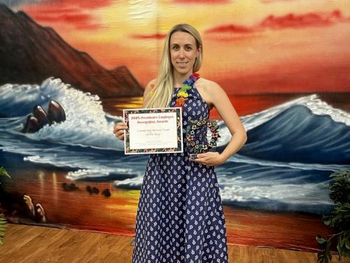 Veronica Farrell accepts an award while chairing SUNY Upstate's Emerging Leaders Unit. A rising star who sought a degree to complement and continue career development, Farrell is graduating from SUNY Oswego with an integrative professional studies degree