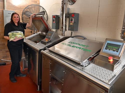 Kelly McKinney, Lakeside Dining Hall building manager, shows the grant-funded new food dehydrator that greatly reduces food waste. 