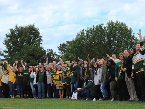 Students, faculty, staff, alumni and administrators gather for the college's annual Green and Gold Day photo.