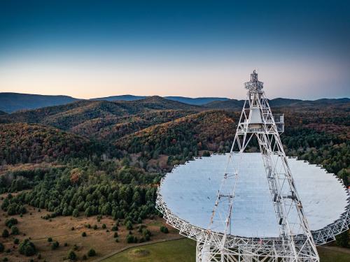 The massive Green Bank Telescope points to the sky, picking up observations in part of a cosmic puzzle researchers try to solve