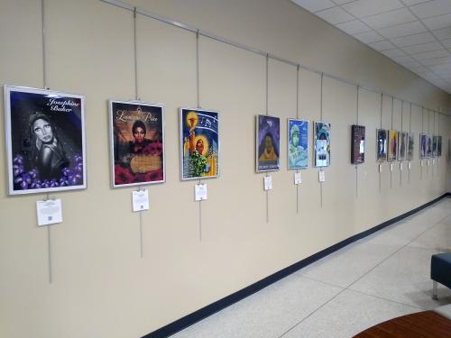 A row of portraits of notable women lines the wall of Penfield Library