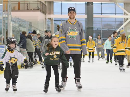 Laker hockey players skate with children