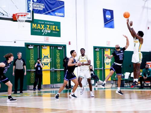 An Oswego men's basketball player goes up for a jump shot during an NCAA Tournament game