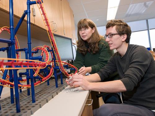 Professor Carolina Ilie and student working on physics of rollercoasters project