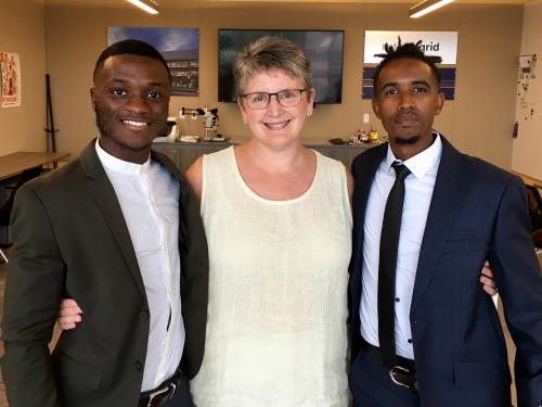 Sandra Bargainnier congratulates two of Oswego's Synergy interns