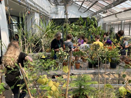 Visitors of all ages tour the SUNY Oswego greenhouse in Shineman Center