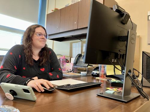 Amy Wallace works on a computer on campus