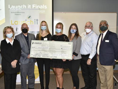 Launch It 2021 winners Molly Bergin and Robyn Kilts with judges and organizers holding a $2500 check