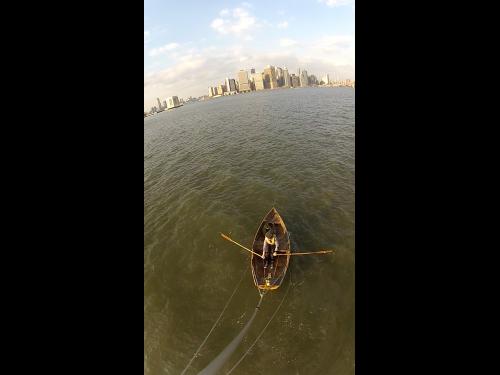 Photo of Marie Lorenz rowing a boat in New York City harbor