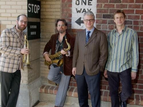 Matt Wilson Quartet standing against a wall, two of them holding horns