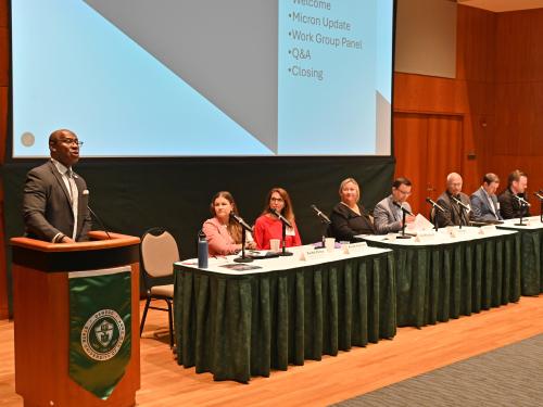 SUNY Oswego President Peter O. Nwosu (at podium) welcomes subcommittee chairs (seated) and attendees to the June 20 Oswego County Micron Strategy Steering Committee Summit