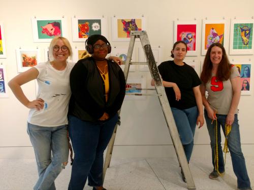 College students prep, hang variety of artwork by schoolchildren in gallery