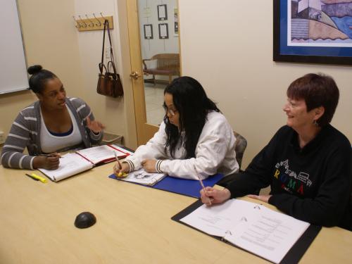 Director Mya Brown and actors working on notes