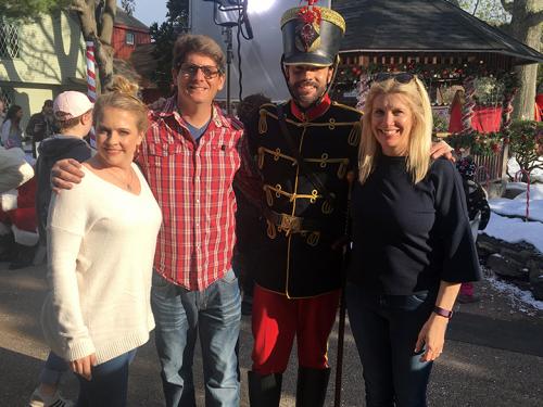 Faculty member Juliet Giglio poses with co-writing husband and stars from A Very Nutty Christmas