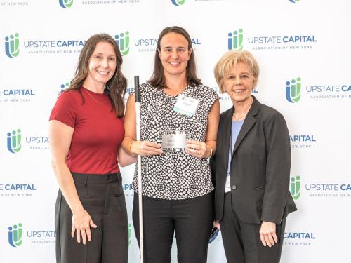 Erin Czadzeck (center), a student in Oswego's online MBA program, is honored for placing second in her division in the New York State Business Plan competition, flanked by Sarah Bonzo (left) and Irene Scruton