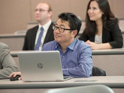 Students with laptops in a classroom