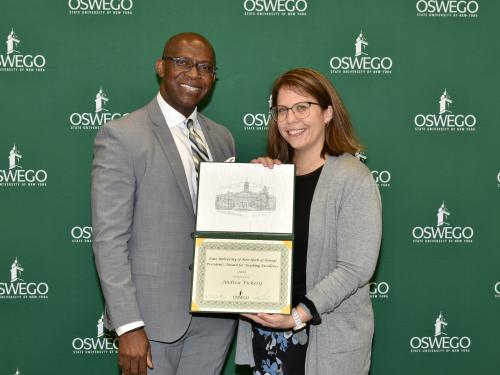 President Peter O. Nwosu presents the President's Award for Teaching Excellence to communication studies faculty member Andrea Vickery