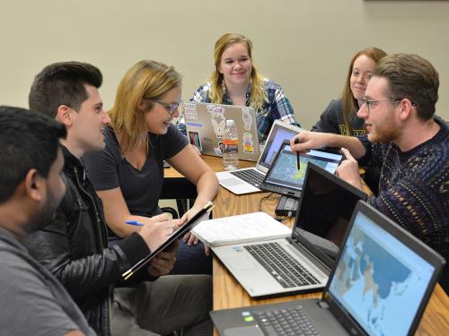 Students discuss a class project