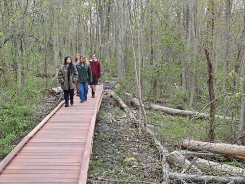 Students attending the grand opening celebration of Rice Creek Field Station's new accessible Purple Trail take a quick stroll.