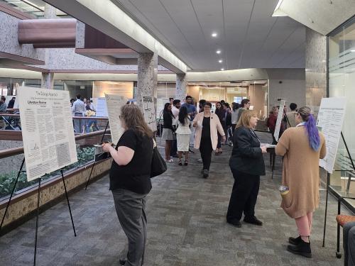 People check out poster presentations at the Syracuse Campus' Quest 2024 display