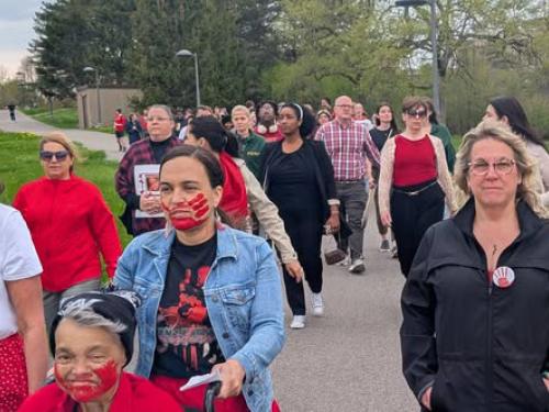 Supporters walk in honor of Red Dress Day, recognizing Missing and Murdered Indigenous Women