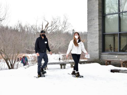 Two students take part in a snowshoe hike at Rice Creek Field Station