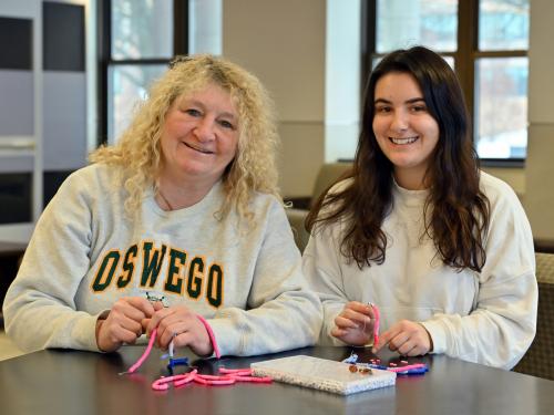 Val Mayer and Jackie Gamlen working with the beads they used at the Destiny Center, creating meaningful moments with the children.