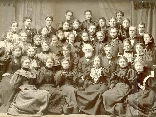 Edward Austin Sheldon surrounded by teachers and students