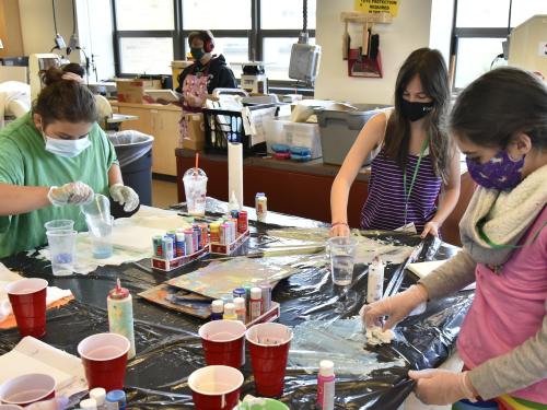 Children work with paint during a previous year's Sheldon Institute