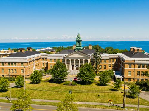 Aerial view of Sheldon Hall in front of Lake Ontario