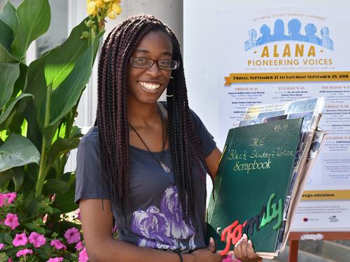 Tenaja Smith-Butler with ALANA poster, scrapbook